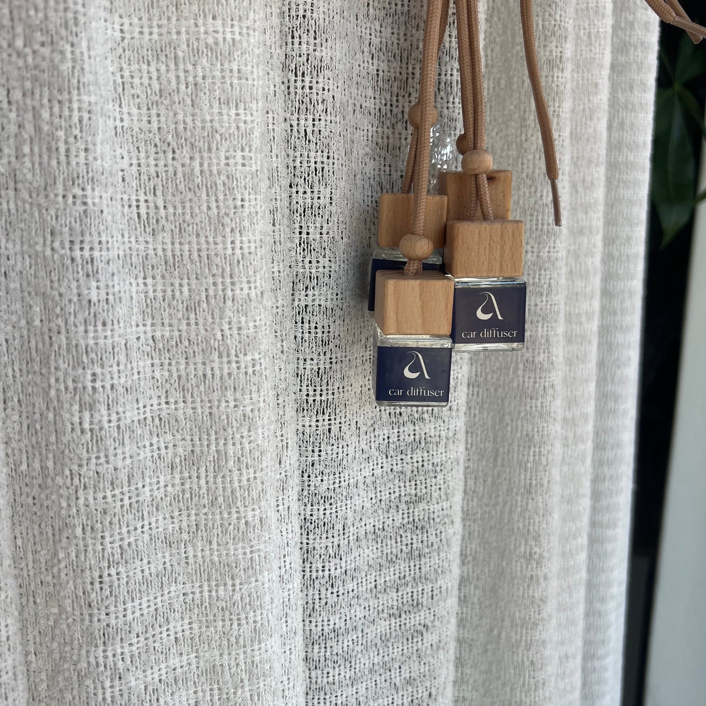 Wooden skewers with dark blue labels in front of a textured surface