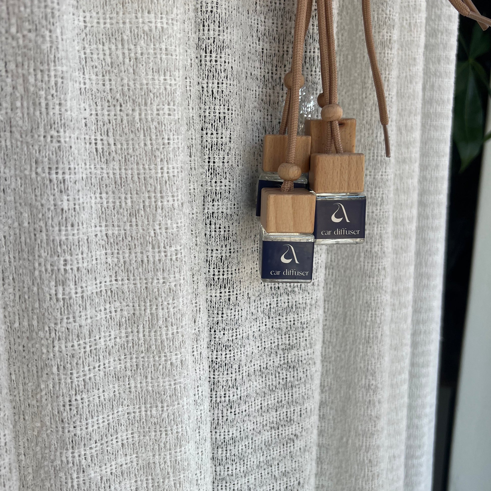 Wooden skewers with dark blue labels in front of a textured surface