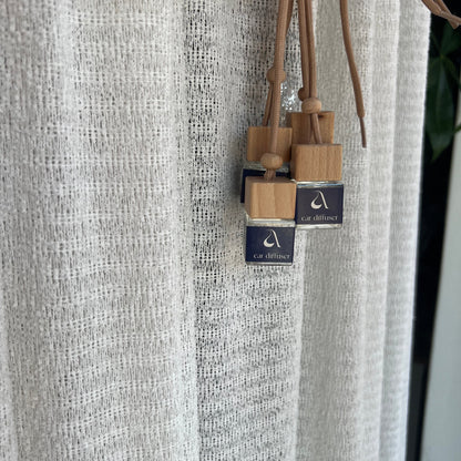 Wooden skewers with dark blue labels in front of a textured surface